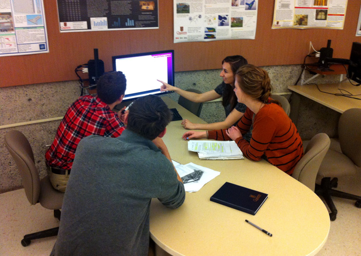 students looking at monitor